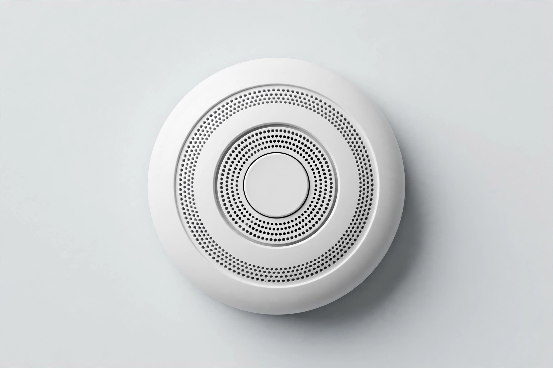 Round white smoke and CO combo alarm with test button