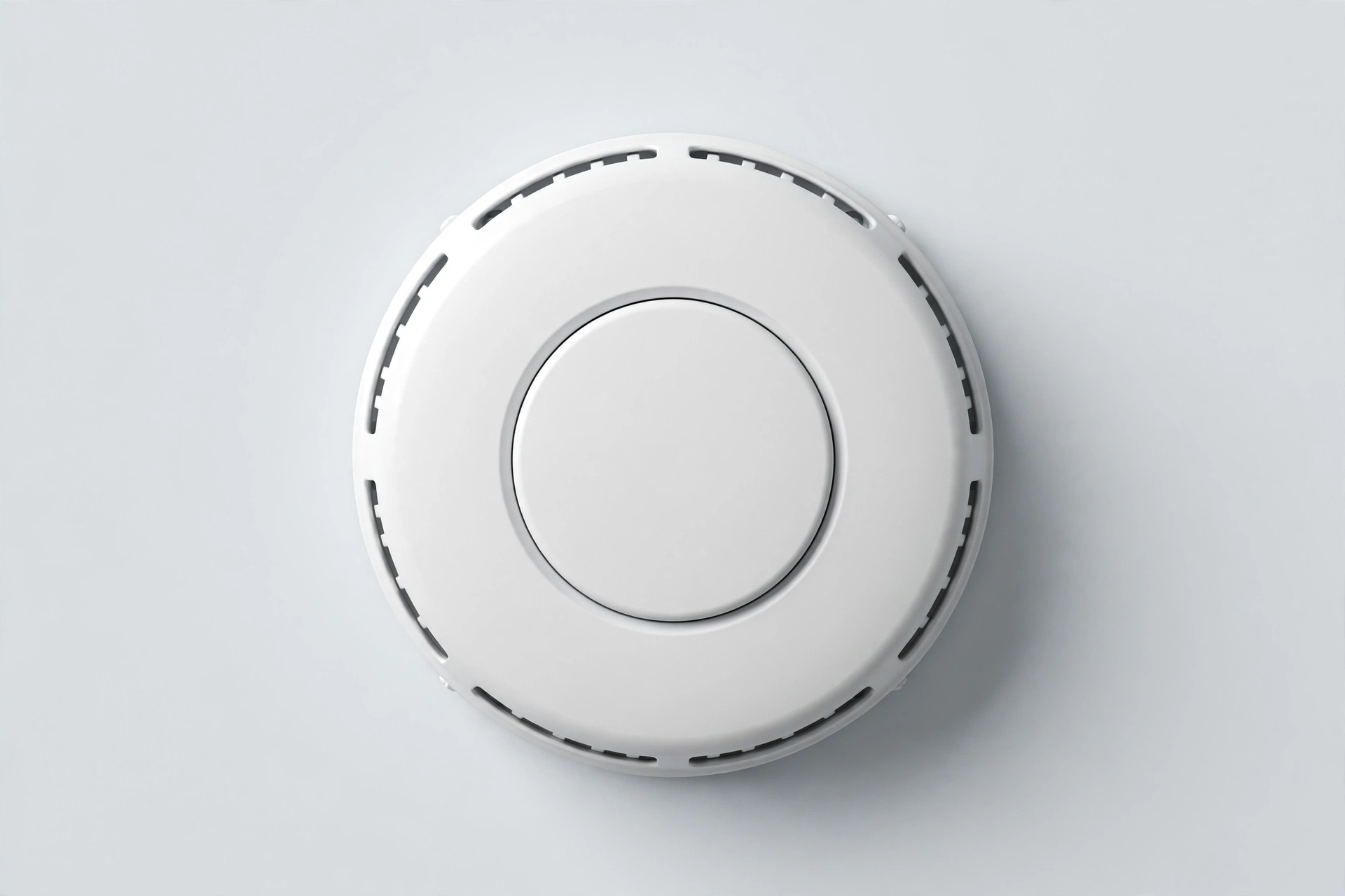 Round white battery smoke and CO detector with center button